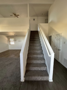 A freshly painted interior staircase and living area by Appleton Residential Services in Rio Rancho, NM.