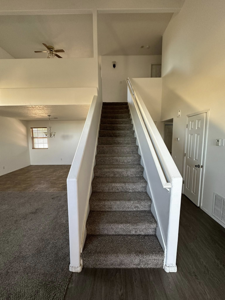 A freshly painted interior staircase and living area by Appleton Residential Services in Rio Rancho, NM.