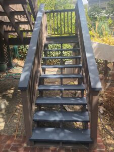 Freshly painted outdoor wooden stairs in a modern dark grey, renovated by Dan's Home and Yard in Oakland, CA.