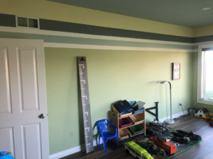 A freshly painted room with light green walls and decorative stripes by Grabill Painting and Drywall in Fort Wayne, IN.