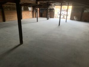 A freshly poured concrete floor inside a barn or large outbuilding, completed by Moons Concrete & Construction LLC in Chicago, IL.