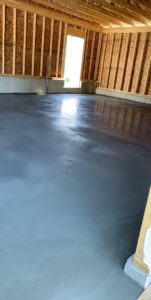 A freshly poured concrete garage floor or interior slab, part of a construction project by Moons Concrete & Construction LLC in Chicago, IL.