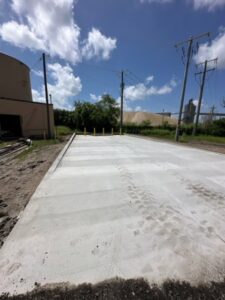 A freshly poured concrete pad or commercial driveway with tire tracks, completed by Bayside Concrete & Construction in Tampa, FL