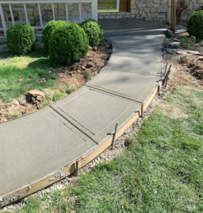 A freshly poured concrete sidewalk with wooden forms in place, installed by Complete Concrete of Indy, Inc. in Fishers, IN.