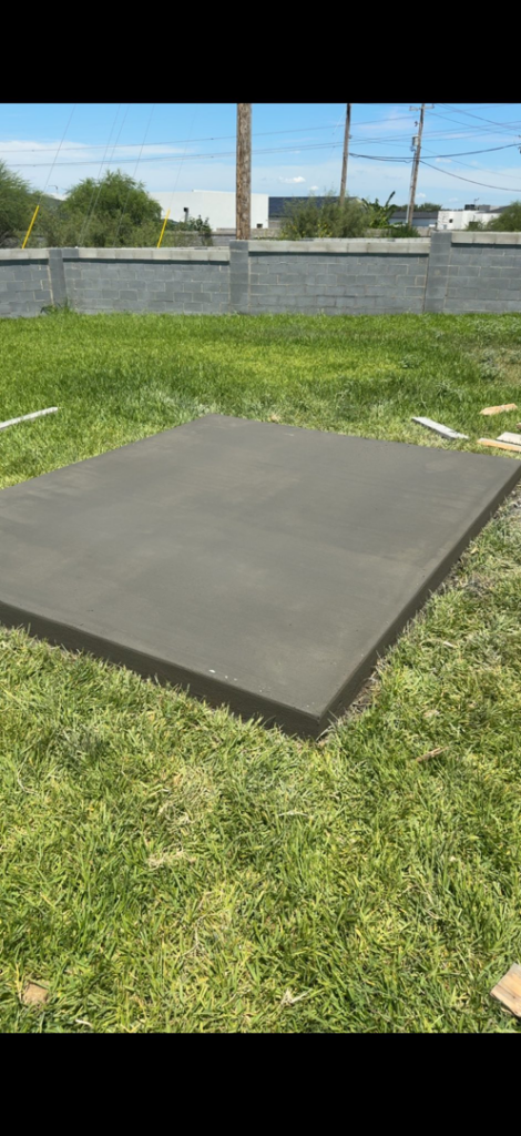 A freshly poured concrete slab in a backyard by Camacho's Construction LLC in Laredo, TX.