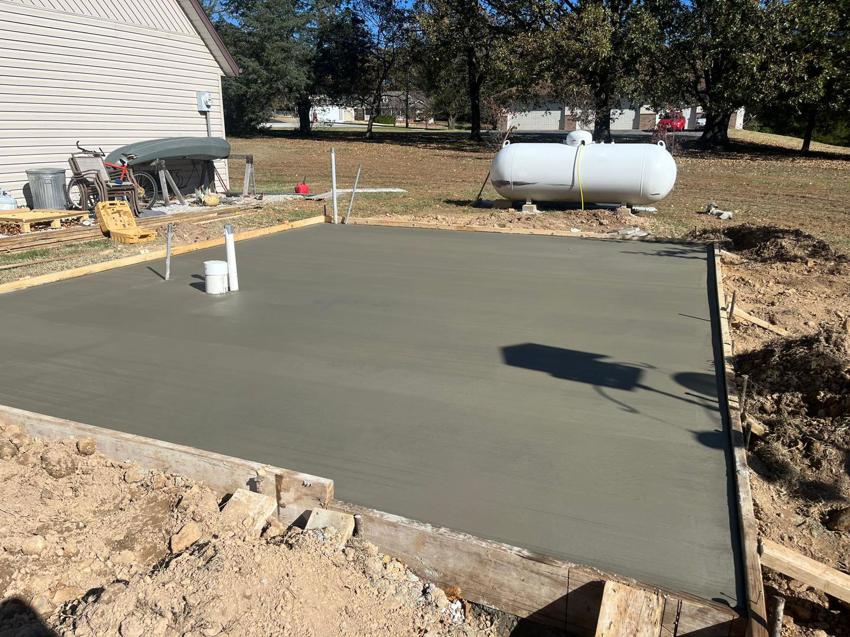 A freshly poured concrete slab foundation for an outdoor addition by Classic Home Concepts in Springfield, MO