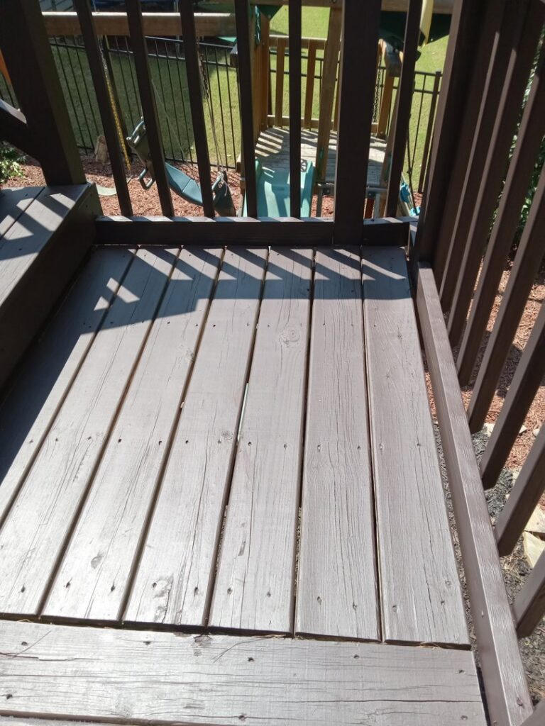 Close-up of freshly stained wooden deck boards by Mels Haul & Junk Removal in Raleigh, NC.
