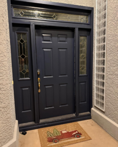 A newly installed dark blue front door with decorative glass by Syd's Handyman Services in Oxnard, CA.