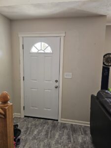A newly installed front door with fresh trim by Urban Restoration, LLC in Indianapolis, IN