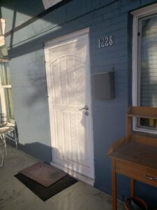 A newly installed white security screen door on a home's entrance, a handyman service by Jesse Roofs Co. in Denver, CO