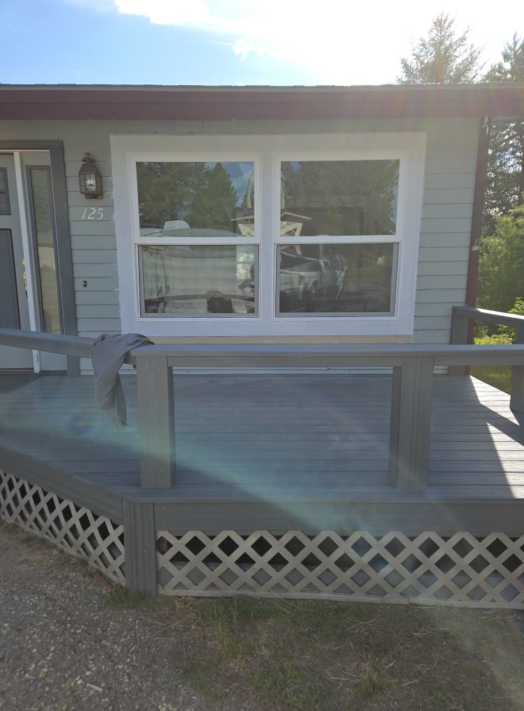Front porch and deck area of a house with new windows and refreshed railing by Stephen Appel Handyman/Contractor in Meridian, ID.