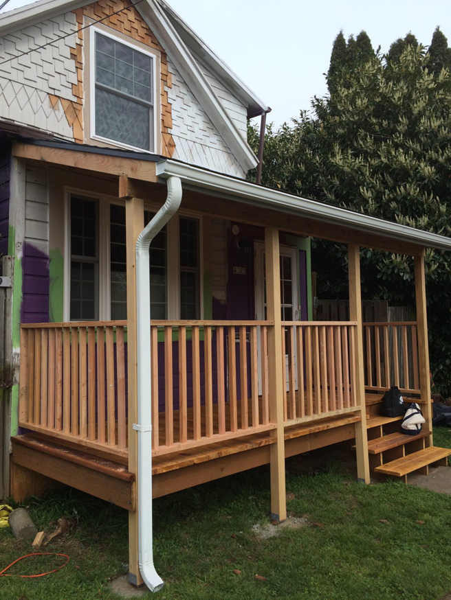 A newly installed front porch with gutter and siding work in progress by Fine Hand LLC in Portland, OR