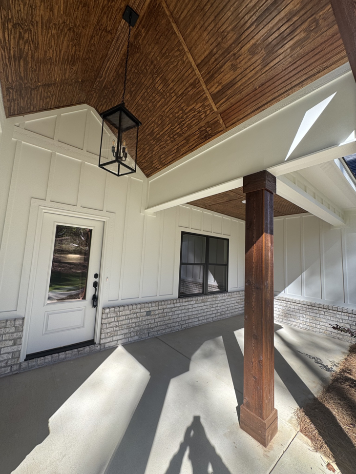 A newly installed front porch light fixture by Adamson Construction Group in Salem, AL.