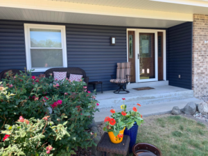 Front porch with new dark blue siding and door installation by Sockett Siding, LLC in Milwaukee, WI