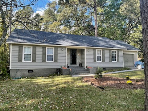 A front view of a house showcasing a newly installed gray shingle roof by Coastal Roofing Solutions LLC in Charleston, SC.