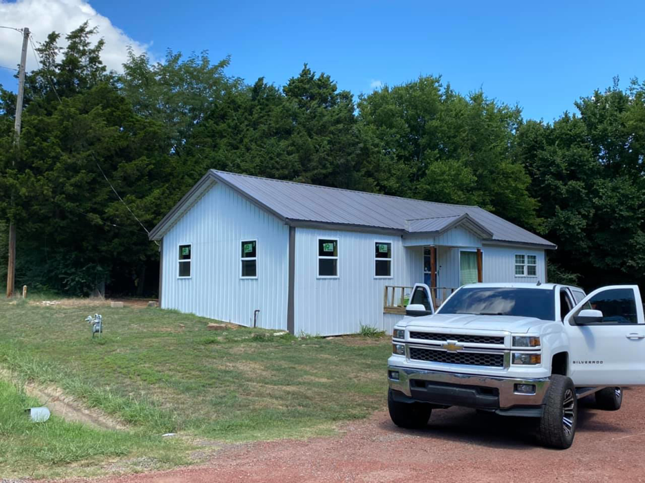 A front view of a renovated house with new metal siding and windows completed by Sterling Renovations in Grapevine, TX.