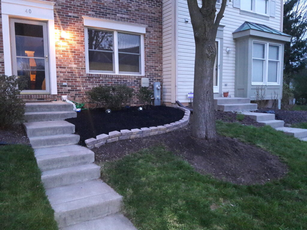 Front yard mulching and lawn care services, showcasing a neat and tidy landscape by C&C LAWN CARE,MOVING & TRASH REMOVAL in Baltimore, MD