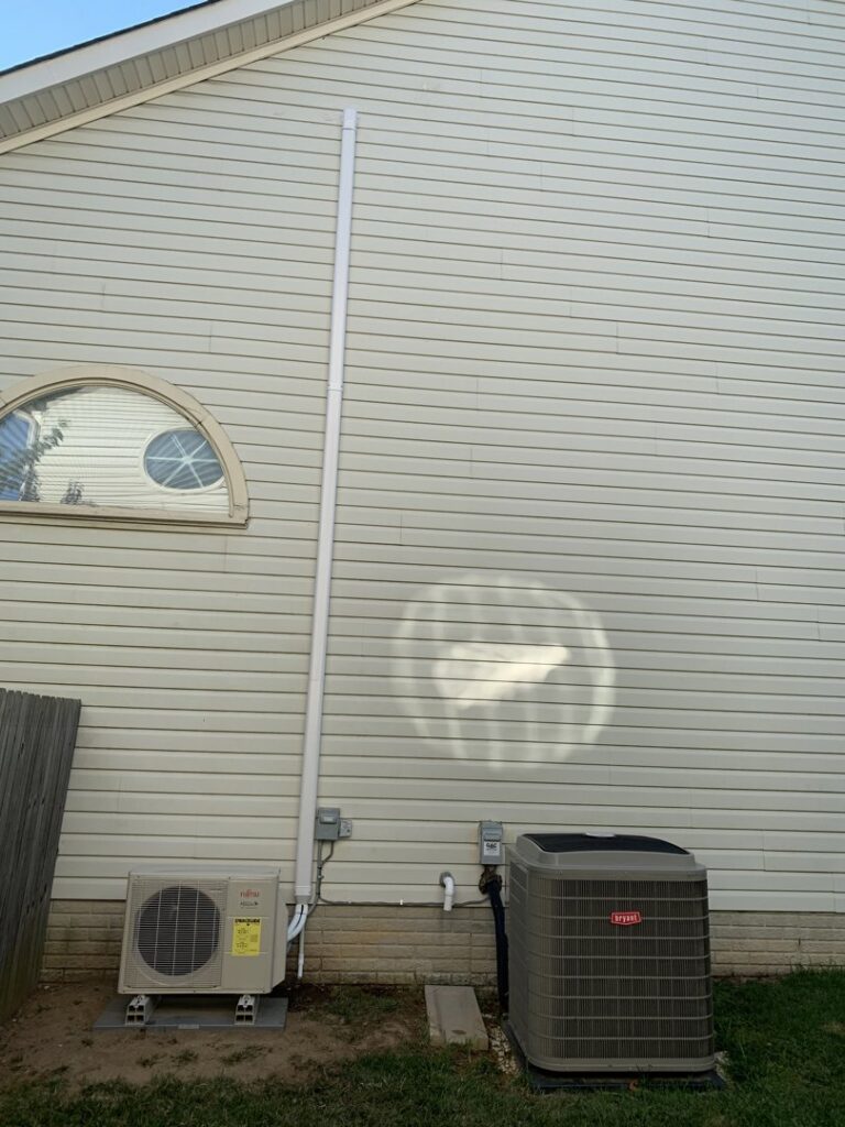 An outdoor Fujitsu mini-split and Bryant AC unit installed at a home by Cold Comfort HVAC Services, LLC in Rockville, MD.