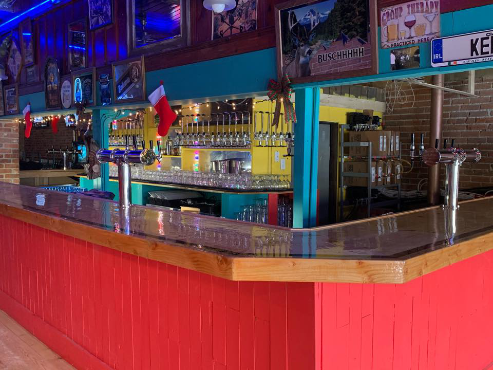 A fully set up bar with multiple beer taps and a polished countertop, installed by Black Tide Beverage in Lakewood, CO.