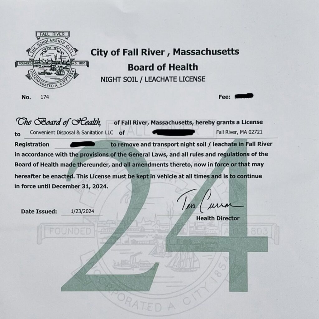 A black dumpster full of construction and household debris in a residential backyard, provided by Convenient Disposal & Sanitation in Fall River, MA.