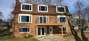 A full exterior view of a house with new windows, doors, and siding installed by Thebco Windows, Doors & Siding in Madison, WI.