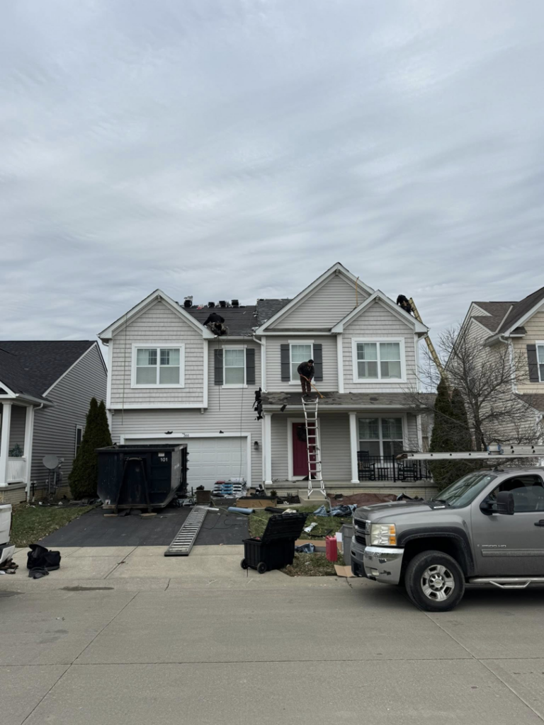 Full house roof replacement project with multiple workers by Darby Builders in Columbus, OH.