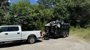 A dump trailer full of trash bags and debris after a junk removal job by The Dump Bros LLC in Raleigh, NC.