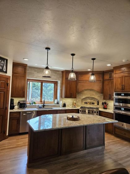 A fully remodeled kitchen featuring a large island, new cabinets, and modern appliances by Boisen Remodeling LLC in Appleton, WI.