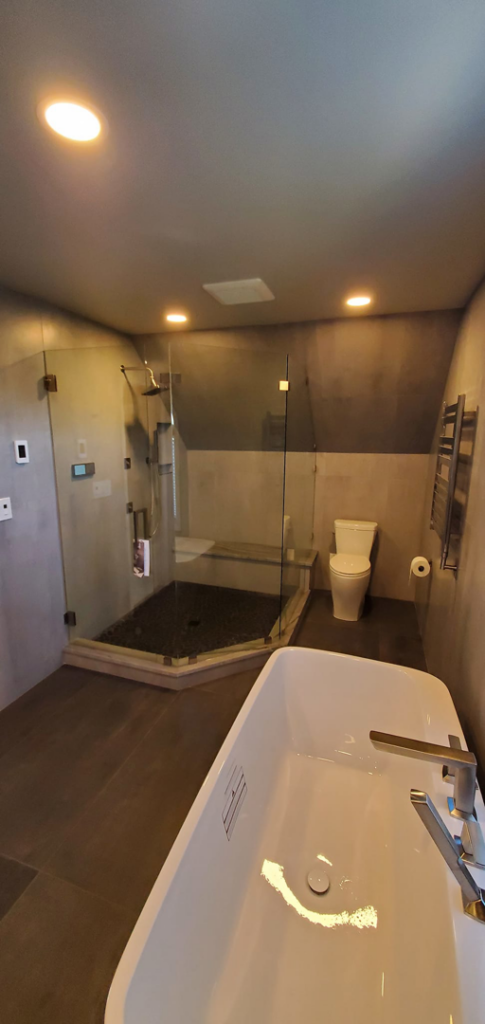 A full modern bathroom remodel featuring a freestanding tub and glass shower by JMS Construction in Las Vegas, NV