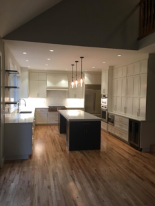 A full view of a modern kitchen renovation with island and pendant lights by Bailey Contracting, LLC in Lake Oswego, OR.