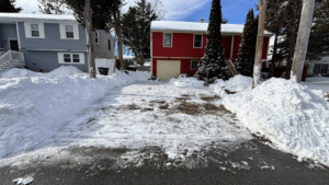 A fully cleared driveway with snow piled on the sides by Build Brothers in Providence, RI