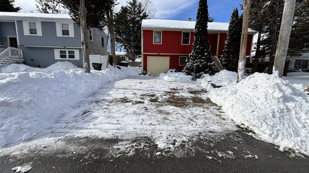 A fully cleared driveway with snow piled on the sides by Build Brothers in Providence, RI