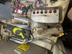 Disassembled furnace parts and tools during a repair by Comfort Mechanical Heating and Cooling in Ann Arbor, MI.
