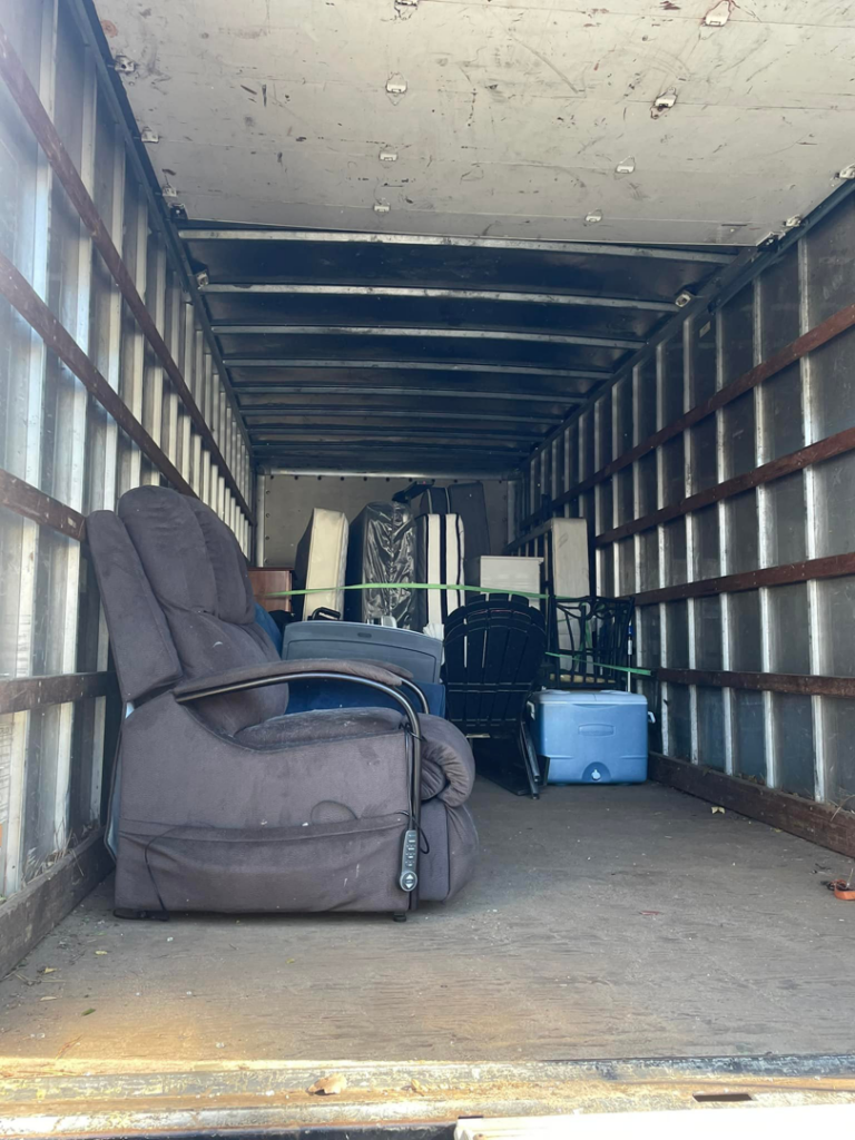 Various furniture and junk items loaded inside a truck for removal by Ty's touch junk removal,LLC in Fayetteville, NC.