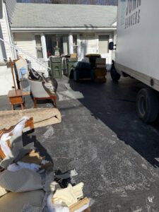 Furniture and household junk awaiting pickup by a Junk Dunkers truck in Wrentham, MA