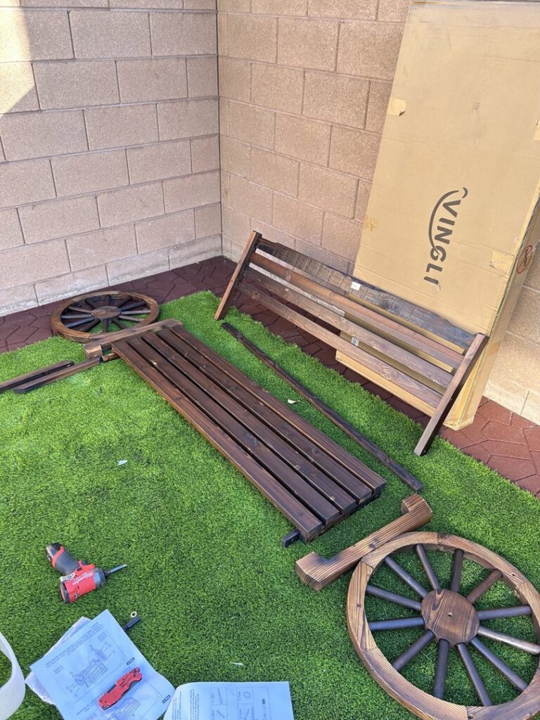 Outdoor furniture assembly in progress with parts and tools by Peak Handyman Services in Las Vegas, NV.