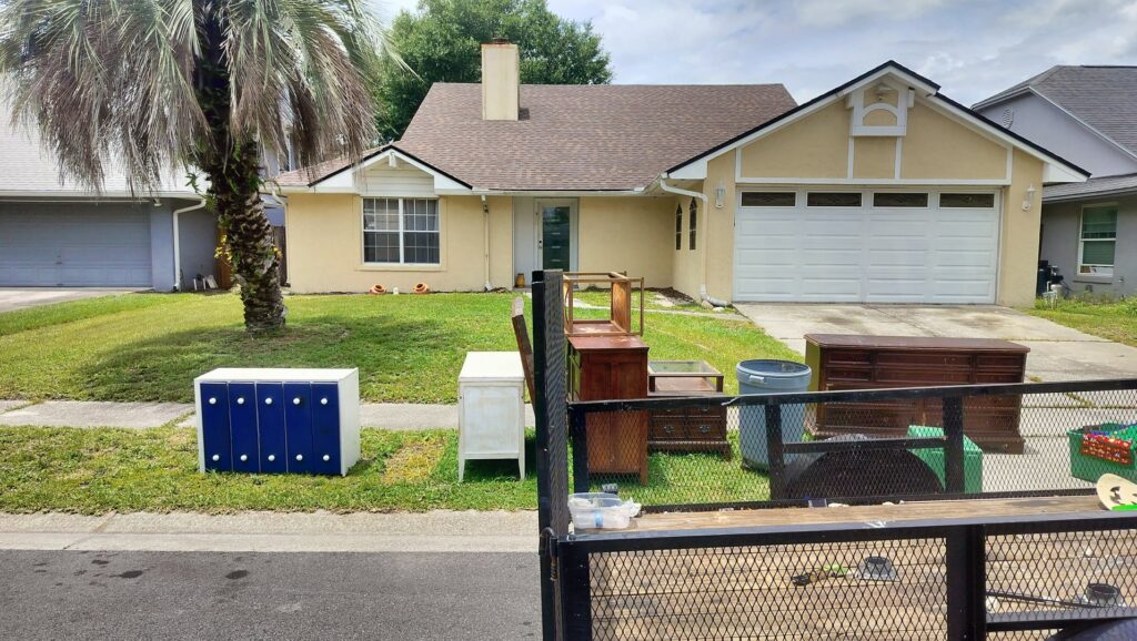 Old furniture and cabinets placed curbside for pickup by Westish Junk Removal LLC in Orlando, FL.