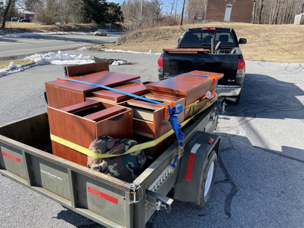 A trailer loaded with old wooden furniture for junk removal by Nu Earth Hauling and Recycling in Allentown, PA.