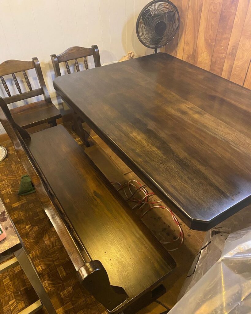 A wooden dining table and bench that have been expertly refinished by In Goode Hands LLC in Beckley, WV.