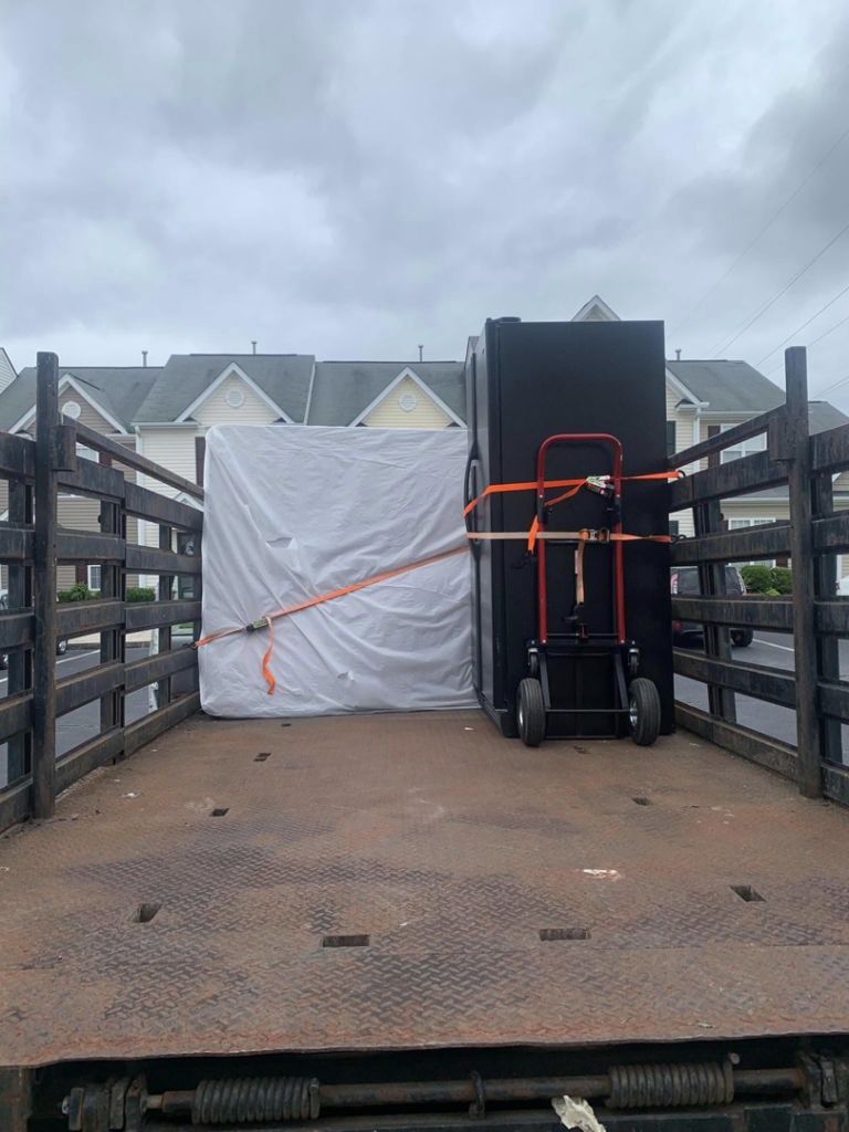 A truck loaded with a wrapped mattress and a safe for junk hauling by Allen's Junk Removal & Hauling in Smyrna, TN.