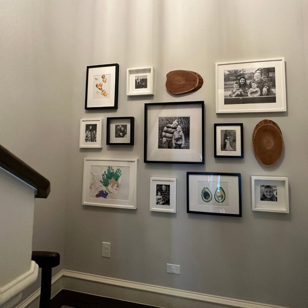 A beautifully arranged gallery wall with framed pictures, installed by I Know A Guy Handyman Service in Cottage Grove, MN.