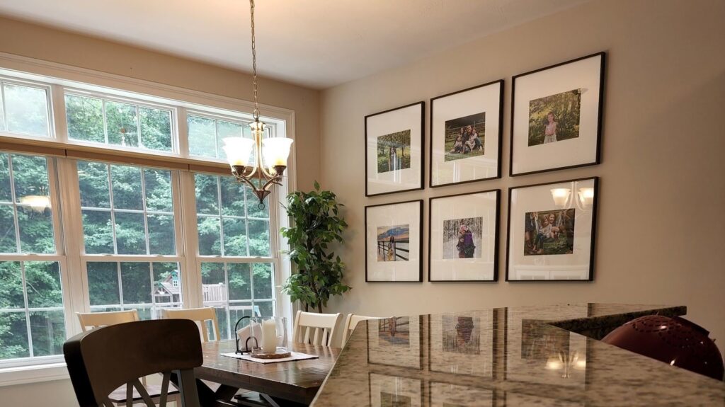 A neatly arranged gallery wall with multiple framed pictures, installed by Dovetails Services LLC in Derry, NH.