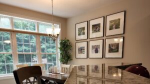 A neatly arranged gallery wall with multiple framed pictures, installed by Dovetails Services LLC in Derry, NH.