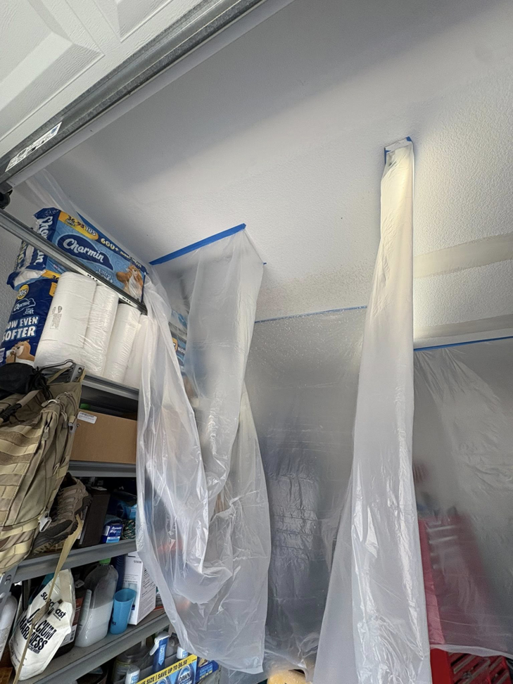 Garage area prepped with plastic sheeting for drywall or painting services by Diamond Drywall LLC in Buda, TX