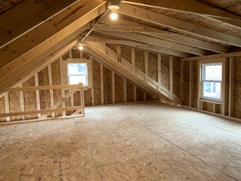 Interior view of a garage attic under construction with exposed wood framing by A-Windy City Garages & Doors in Chicago, IL.