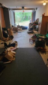 A cluttered garage filled with items ready for junk removal and cleanout by JDog Junk Removal & Hauling Capital Region NY in Schenectady, NY.