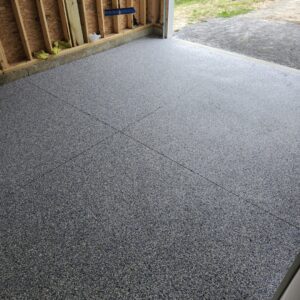 Epoxy flooring installed in a garage during its construction phase by Epoxy Evolution, a general contractor in Albany, NY.