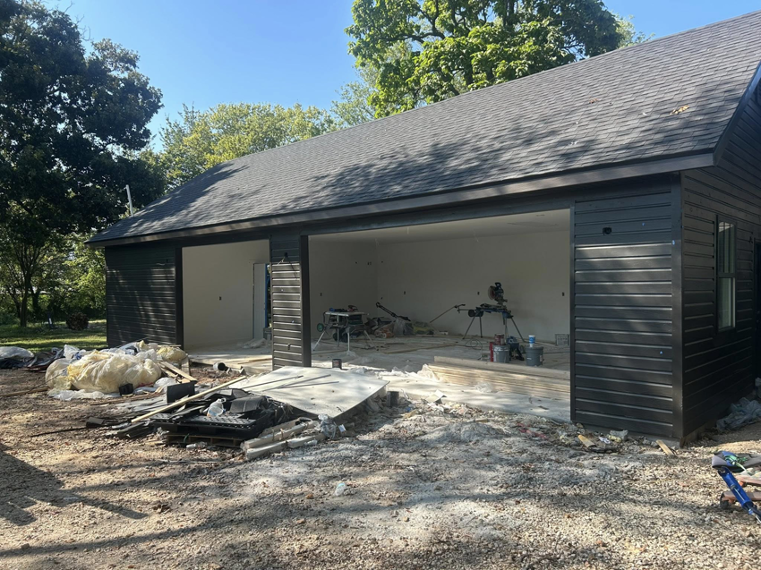 Garage construction in progress, showing tools and materials inside the bays by Old Things Created New Handyman Service in Springdale, AR.