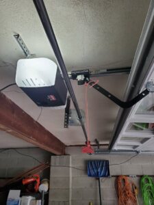 An installed garage door opener and tracks, showcasing work by Lucas Overhead Doors in Erie, PA.