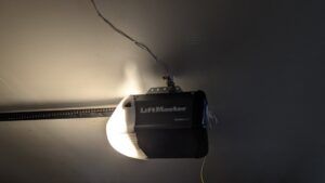 A LiftMaster garage door opener installed on a ceiling, representing a handyman service by Lula - Reinventing Property Maintenance in Overland Park, KS.